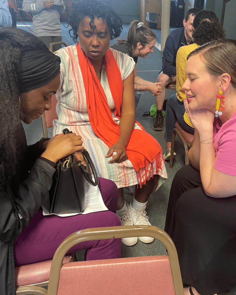 A diverse group of women praying together at MissionSmith: Centering Discipleship hosted by the Cleveland Local Network
