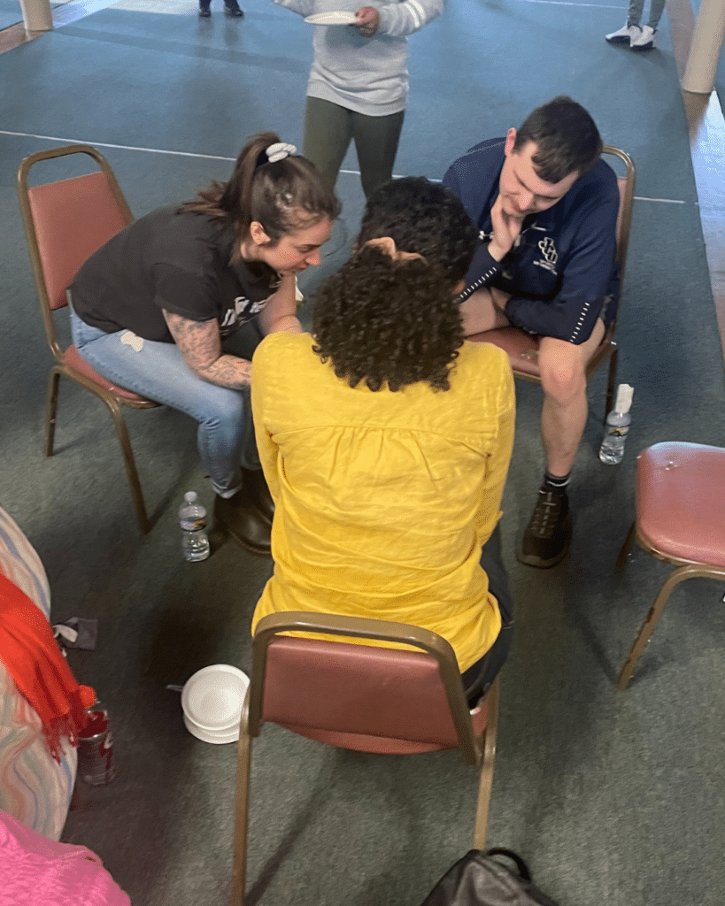 Two women and one man praying together at MissionSmith: Centering Discipleship hosted by the Cleveland Local Network