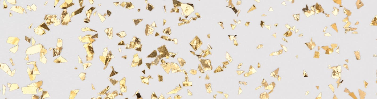 Gold confetti on white background